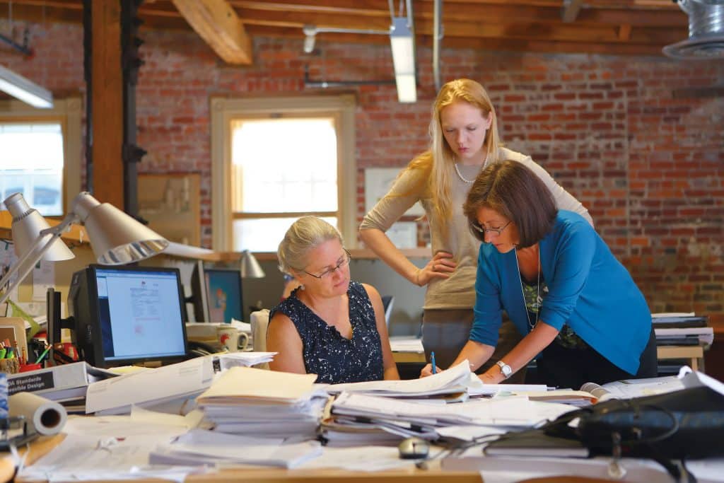 Lori Snyder ’79 Garrett, right, collaborates with colleagues at Glavé and Holmes Architecture. Photo courtesy of G&H.