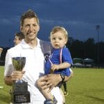 Andrew celebrates state soccer win with Forrest, 2015