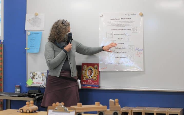 Lynette Mast reviews the kindergarten classroom Peace Pledge, signed at the beginning of the year