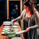 Kirsten Moore puts finishing touches on a dish for a Sub Rosa meal