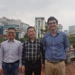 Caleb poses with Tran Doan Lam (center), the director of Thế Giới Publishers, and Pham Tran Long, head of Thế Giới's English department, at their office in Hanoi. 