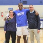 Aviwe Mahlong, with host parents Chad and Jessica Seibert at the varsity boys basketball senior night, 2020.