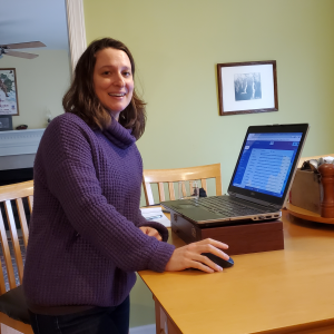 Trisha Blosser, development officer, at her high tech home standing desk. Photo credit: her boys