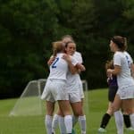 Girls varsity soccer celebrating a goal in 2019