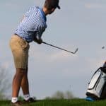 Adam Hatter '22 watches his chip head toward the green in a 2019 match.