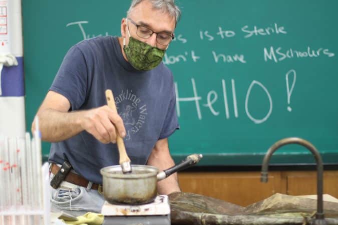 Lee Good, making tin cloth for a distance learning video lesson