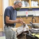 Lee Good, making tin cloth for a distance learning video lesson