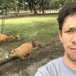 Andrew Jenner self portrait with some capybaras in Sao Paulo, Brazil, in June 2018, while reporting a story about birds and bird watching activism in the city for Birding magazine.