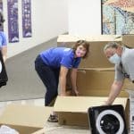 Shannon Roth, Anna Harrar and Jennifer Young unpack air filters for classroom air quality, COVID-19 era