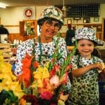 Ellen Helmuth at her Farm Market stall with granddaughter, Julia, 1997. Julia is pleased with having just made a sale of cut flowers. 