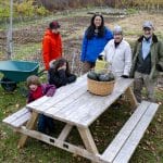 Ellen and Keith Helmuth at the Woodstock Community Garden with family gardeners, 2019.