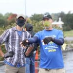 Andy Hershberger confers with his former soccer coach, Kendal Bauman at the solar barn raising