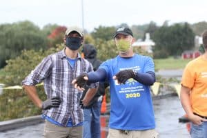 Andy Hershberger confers with his former soccer coach, Kendal Bauman at the solar barn raising