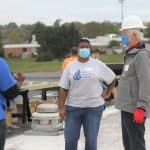 Debbie Katz, high school counselor, with Tony Smith of Secure Futures, talking with Nikita Stoll at the solar barn raising