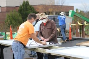 Jeff Heie, communty volunteer coordinator, and Earl Martin at the solar barn raising