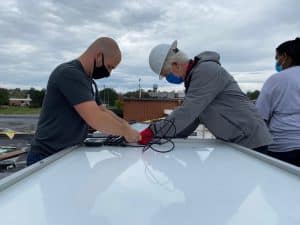 Everett Brubaker '10 and Tony Smith of Secure Futures at the solar barn raising