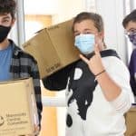 Students carry in boxes completed at home over the weekend for the National Honor Society food box collection for Capital Christian Church, Nov. 2020