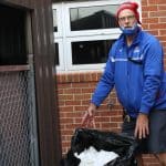 Kendal Bauman, faculty club sponsor, brings elementary school compost to the main collection bins each week.