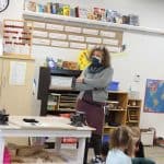 Lynette Mast hears kindergarten students share ideas on what a promise means as they review their peace pledge poster.