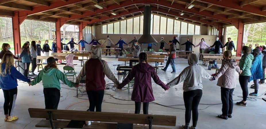 Touring Choir members held hands and sang Benediction for the first time in more than a year. Photo by Christine Fairfield.