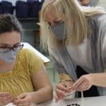 Ruby Kauffman '83 Hostetler taught macrame to the jewelry crafting group. Ruby operates Paper Nest Studios.