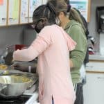 Student bakers preparing items for golfer goodie bags