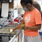 Student bakers preparing items for golfer goodie bags