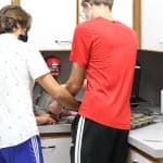 Student bakers preparing items for golfer goodie bags