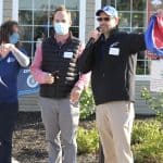 Trisha Blosser, EMS development; Mattias Clymer, alumni board and golf committee, draw a name for a Pepsi-Cola door prize