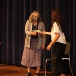 Maria Archer presents certificate at 8th grade graduation 2021