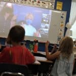 Second grade students practice American Sign Language, led by the 4th grade students. 