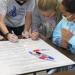 Fifth grade students take turns singing the peace pledge, 2021