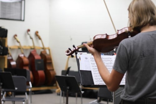 Miriam on violin in strings music room