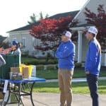 Golf coach Chris Slonaker chats with Justin King,  high school principal,  and Andrew Gascho, athletic direcotr.