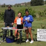 Eric Martin '72, alumni board member, and Student athlete volunteers