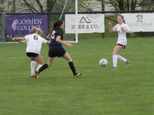 Varsity Girls Soccer in front of Athletic Banners