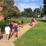 Elementary students make their way from the lower building to the upper building dining hall for lunch during the first week