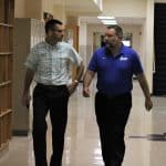 Paul Leaman and Mike Stoltzfus discussing the many details to finalize before the first day of school