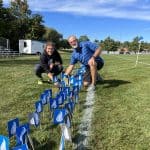 1,000th boys varsity soccer celebration: Coach Eshelman-Robles and Coach Kendal Bauman planting flags