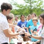 Luke Rogers, SCO president 2022-23, serves up root beer floats during SCO Beach Day, spring 2022