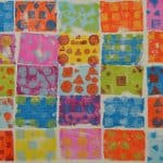 Title: The Colorful GhostsSize: 24”x18”Media: acrylic paintDescription: 1st grade artists used printmaking to create a colorful quilt-like composition. Each student rolled paint onto a rectangular piece of foam and stamped the shape onto the wooden panel. After designing a printmaking block with foam shapes, they rolled paint onto it and stamped it directly over their solid block of color. Students repeated this process with a partner to create a second print. These student pairs practiced sharing their ideas for design and color choices. The last printed block was created by the entire class. As the final step in their creative process, the class brainstormed title ideas for their piece then voted for their favorite.