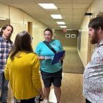 Teachers convene in the upper hallway