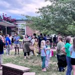 Students and families socialize outside.