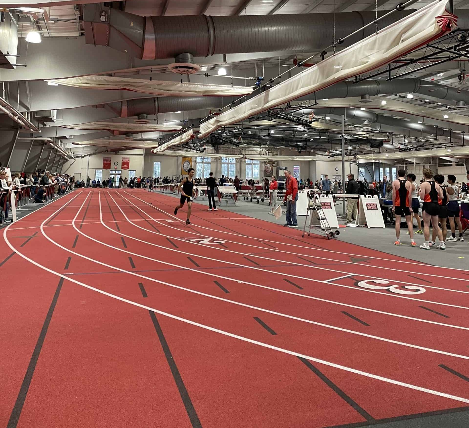 Luga Samson runs his leg of the relay at the Indoor Track State Championship 